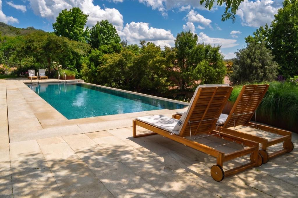 two lounge chairs sitting next to a swimming pool at Lalisea in Talaveruela