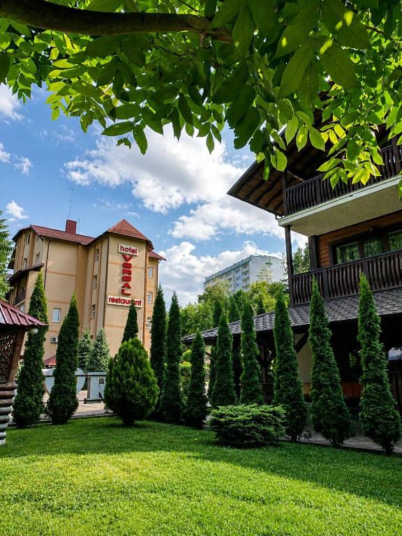 a hotel with a lawn in front of a building at versal in Ternopil