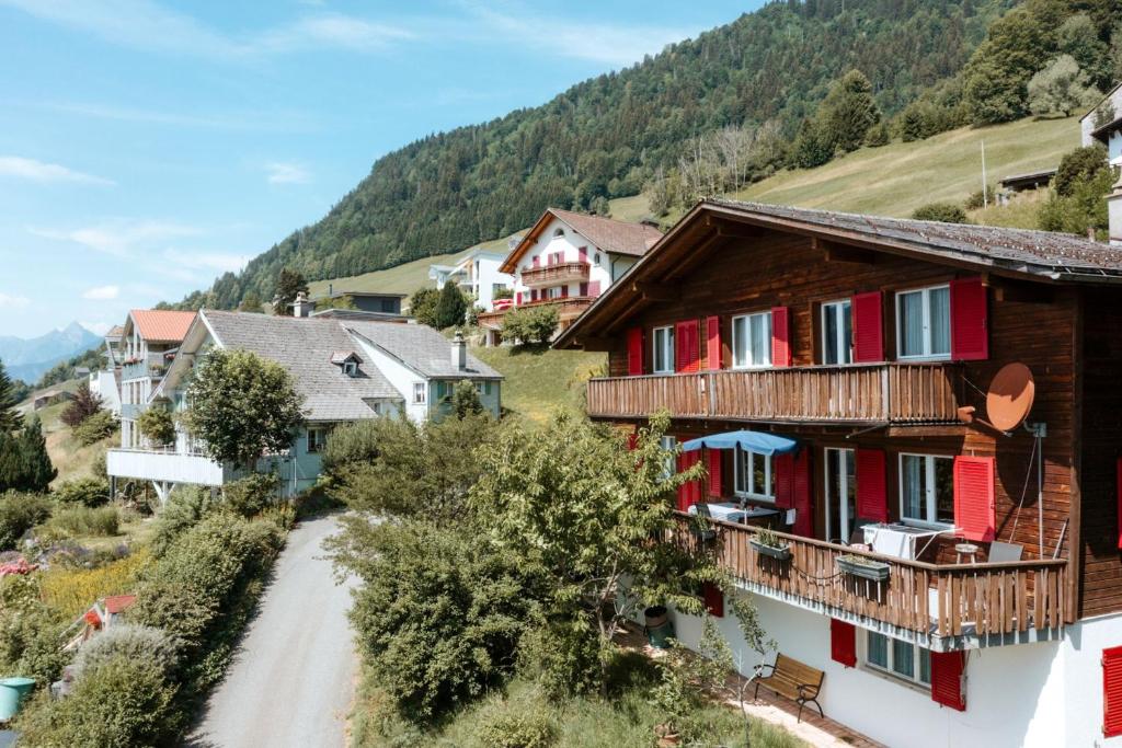 a village in the mountains with houses and a road at Apartment im Chalet Sidonie in Amden