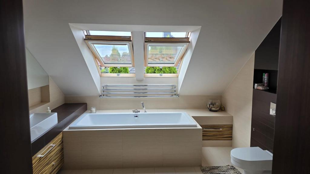 a bathroom with a large bath tub and a window at sPokój na Marsa in Straszyn