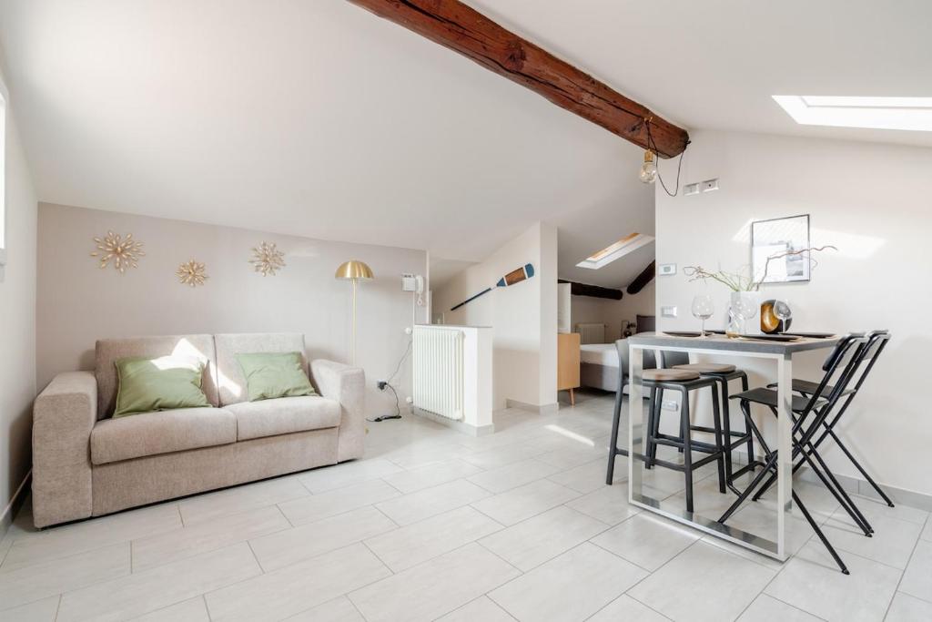 a living room with a couch and a table at Lake View - Gardone Center - Private Garage in Gardone Riviera