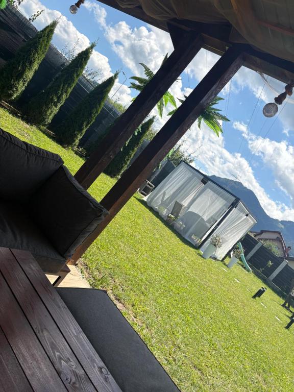 a view of a yard with a bench and a tent at MIK Chalet in Săcele