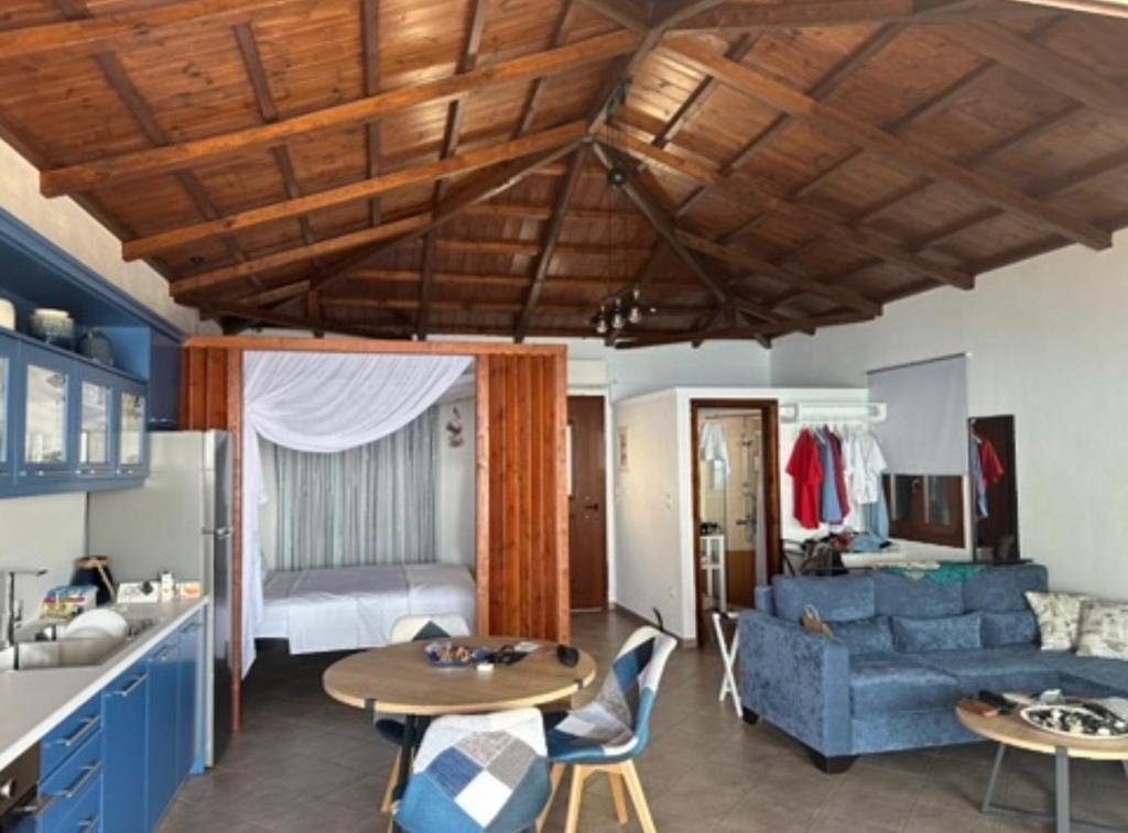 a living room with a blue couch and a table at Casa Gaia - Unit 1 in Glossa