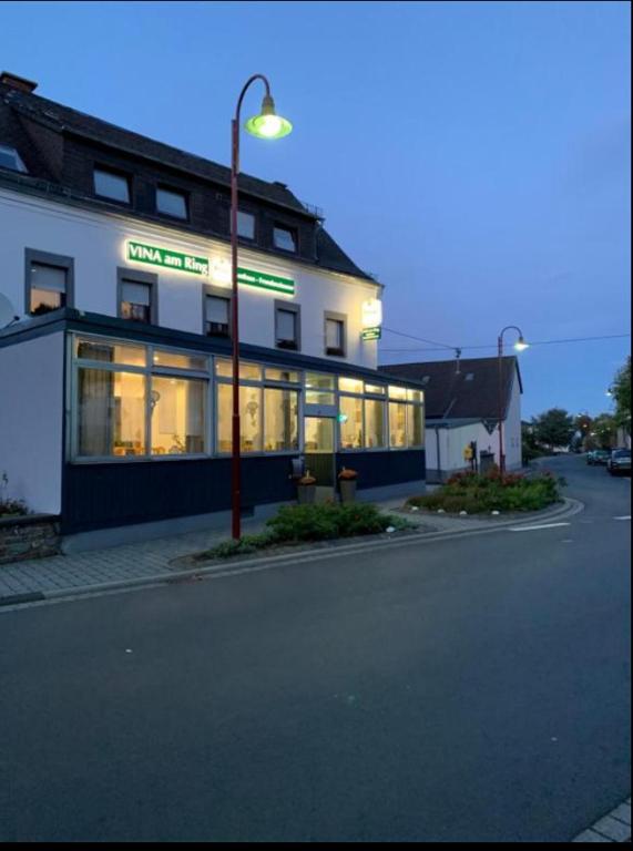 a building with a street light in front of it at Vina am Ring in Mannebach