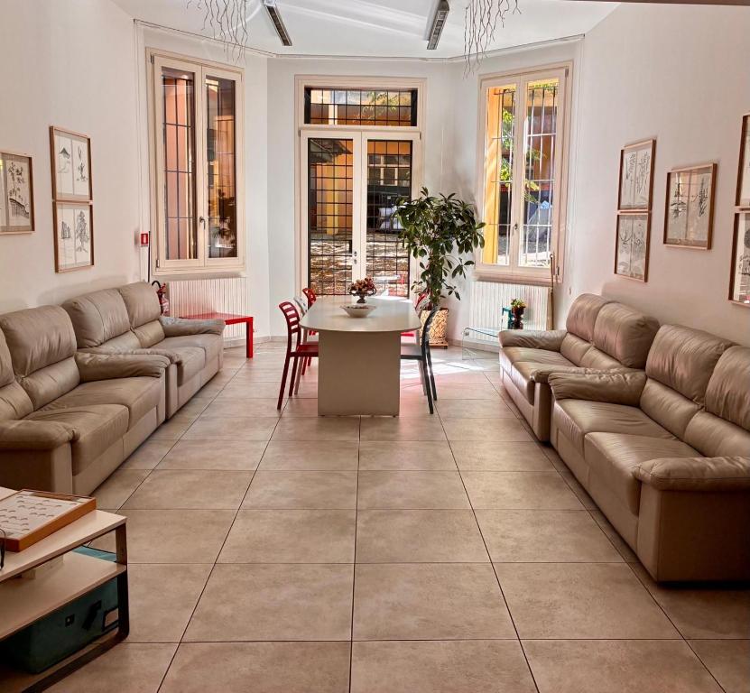 a large living room with couches and a table at Residence Cavazza in Bologna