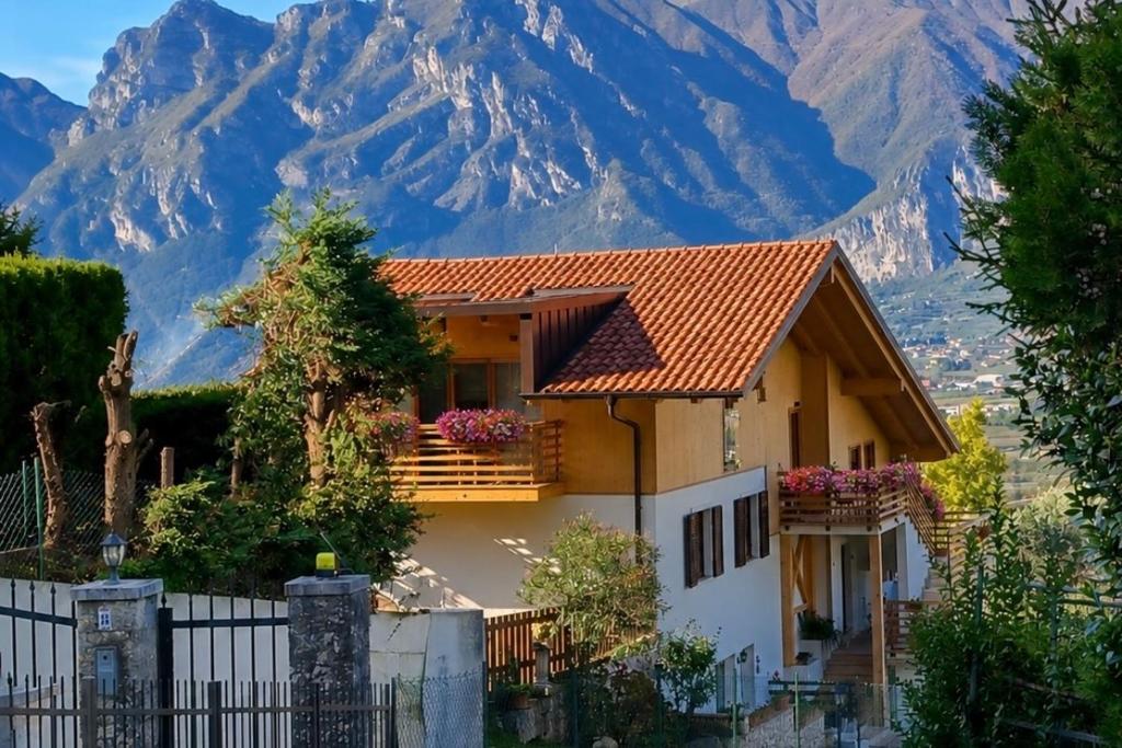 a house with a fence in front of a mountain at La Villa in Arco
