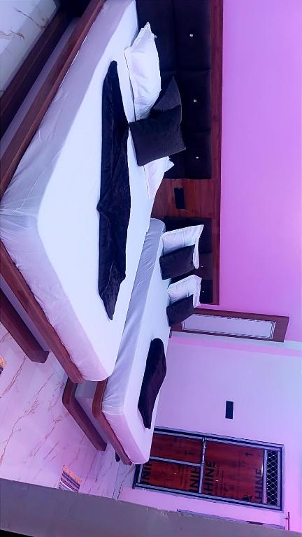 a bed in a room with some pillows on it at Shri Goara palece in Godarpura