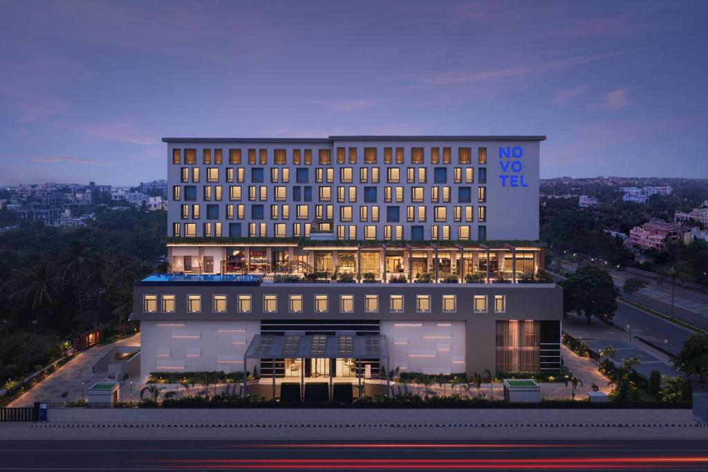 a large building with lights on top of it at Novotel Bhubaneswar Janpath in Bhubaneshwar