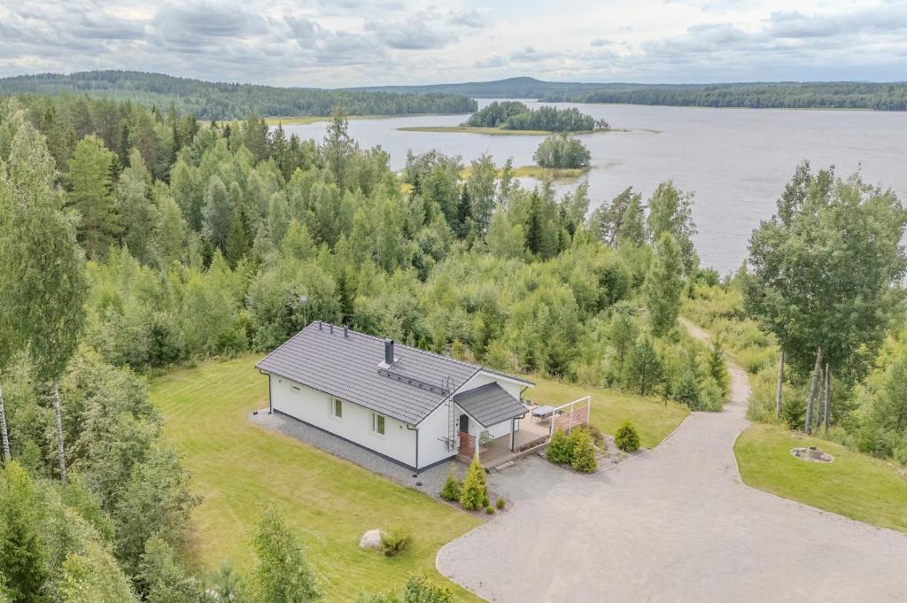 an aerial view of a house on the shore of a lake at Villa Vilkama 2 cabins Lake view, incl indoor hot tub, sauna in Laukaa