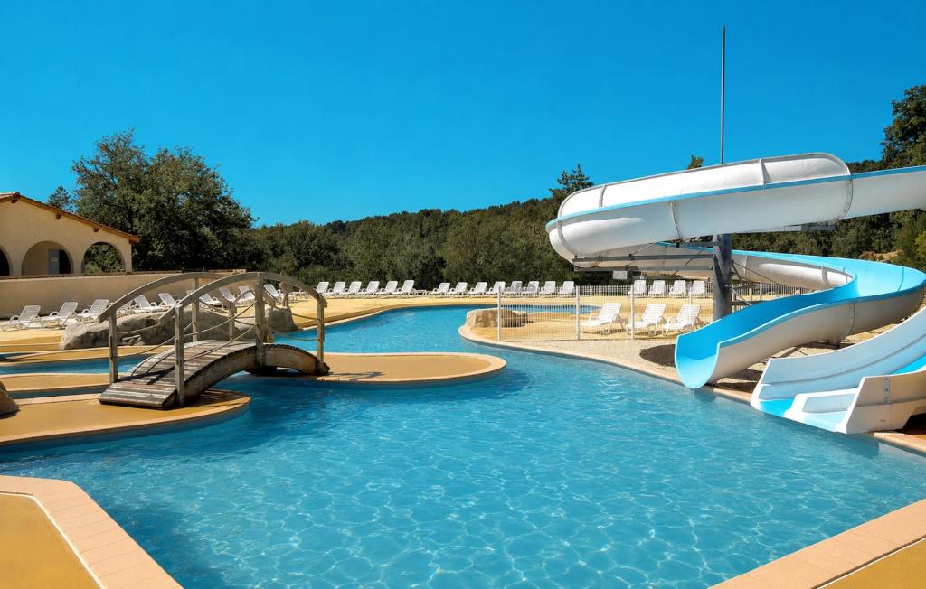a swimming pool with a water slide in a resort at Soleiou in Salavas