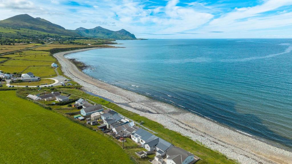 an aerial view of a beach with houses and the ocean at Beach Bungalow in Nefyn