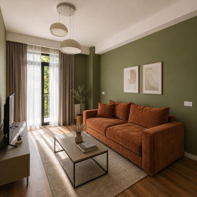 a living room with a couch and a table at Matilda Signature Apartments in Telavi