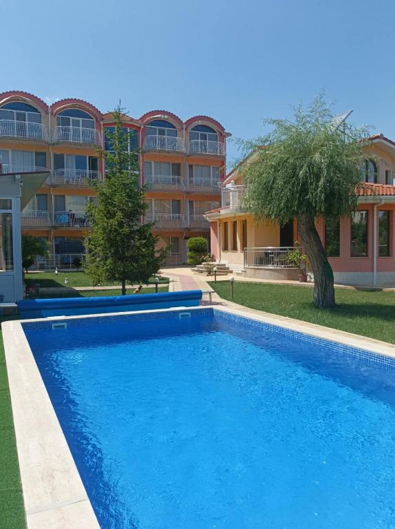 a large swimming pool in front of a building at Sunny House in Kranevo