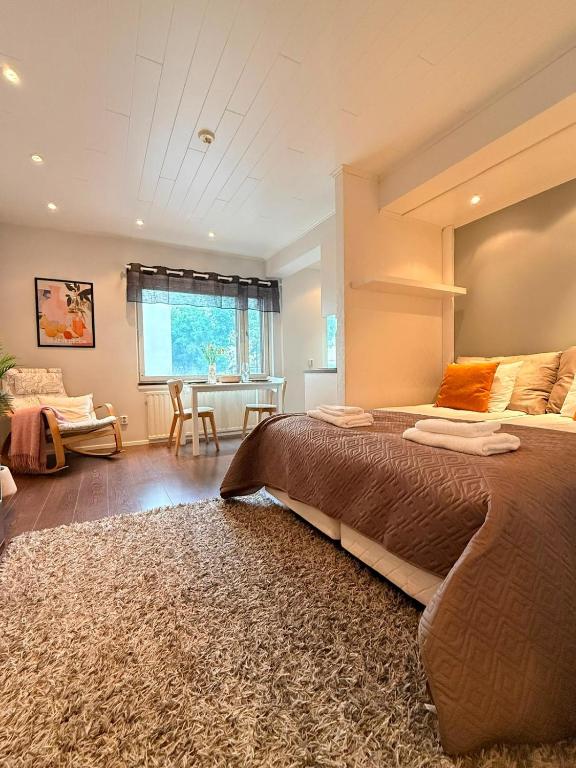 a bedroom with a large bed and a table at KODA Walk Everywhere in Rovaniemi