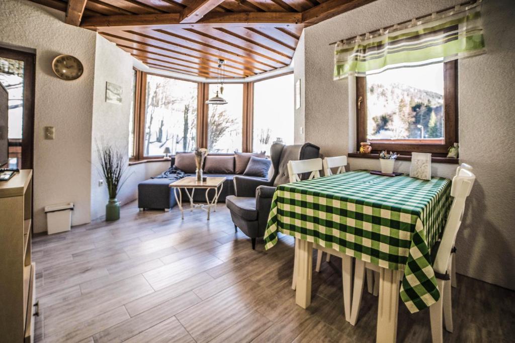 a living room with a table and a couch at Apartmán Chopok Juh Romantika 14 in Tale