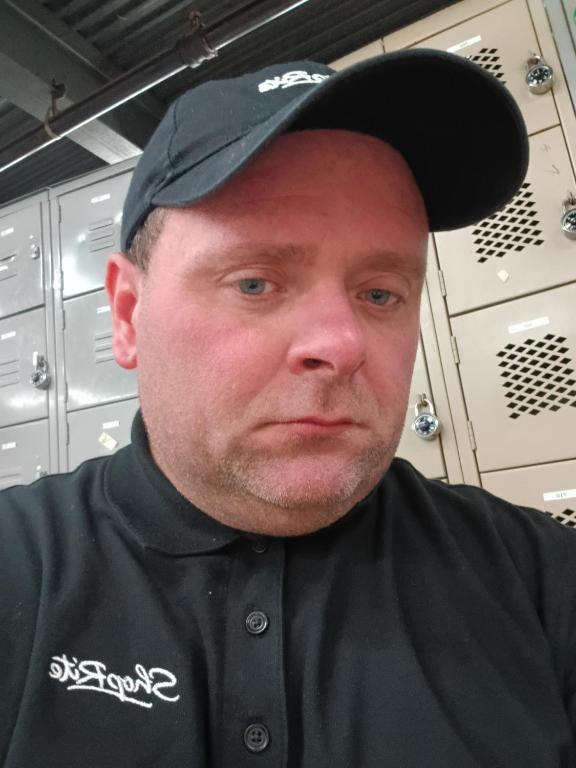 a man wearing a black shirt and a hat at Super 8 in East Rutherford