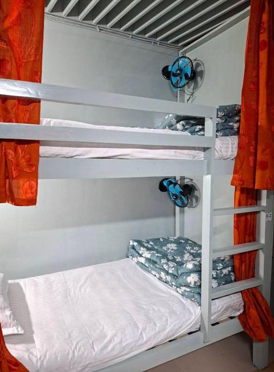 a bedroom with bunk beds in a room at International Dormitory Mohsin Plaza in Sreemangal