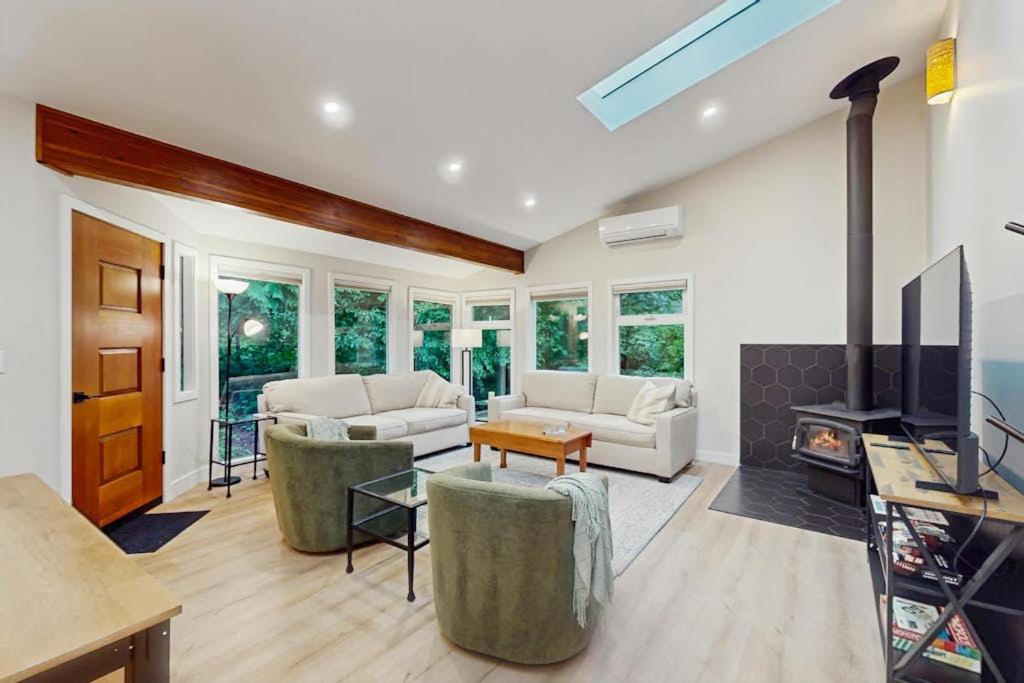 a living room with two couches and a fireplace at Sanctuary on Park Ave in Hawley
