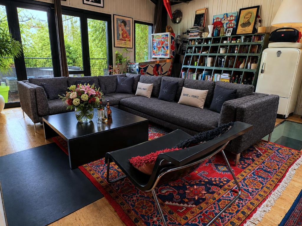a living room with a couch and a coffee table at Villa Georges in Issy-les-Moulineaux