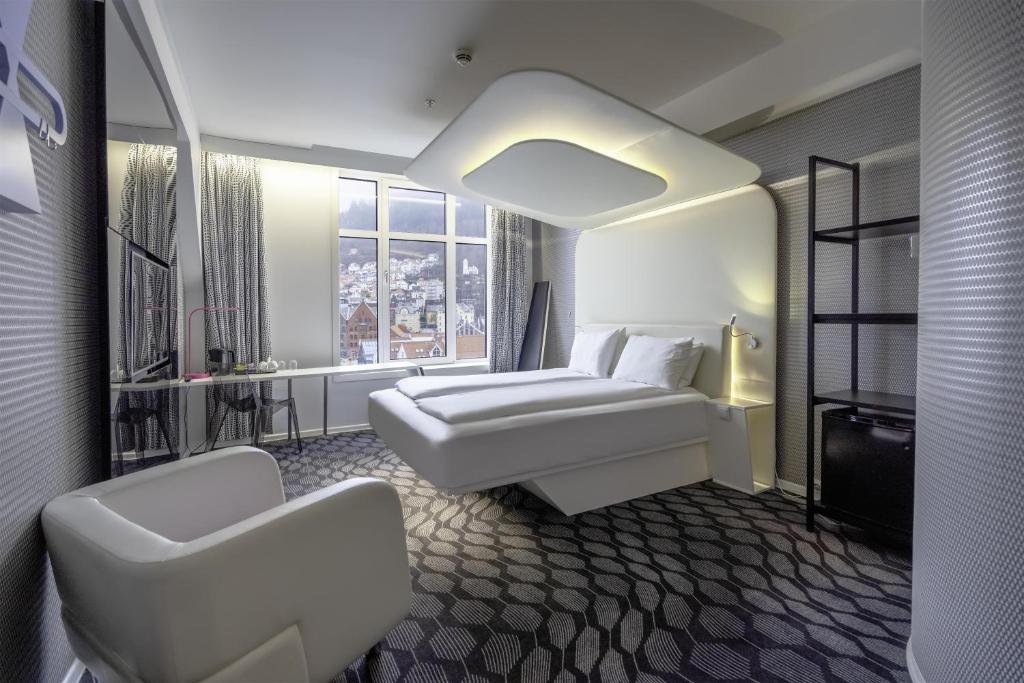 a hotel room with a bed and a window at Magic Kloverhuset Harbour Hotel, a member of Radisson Individuals in Bergen