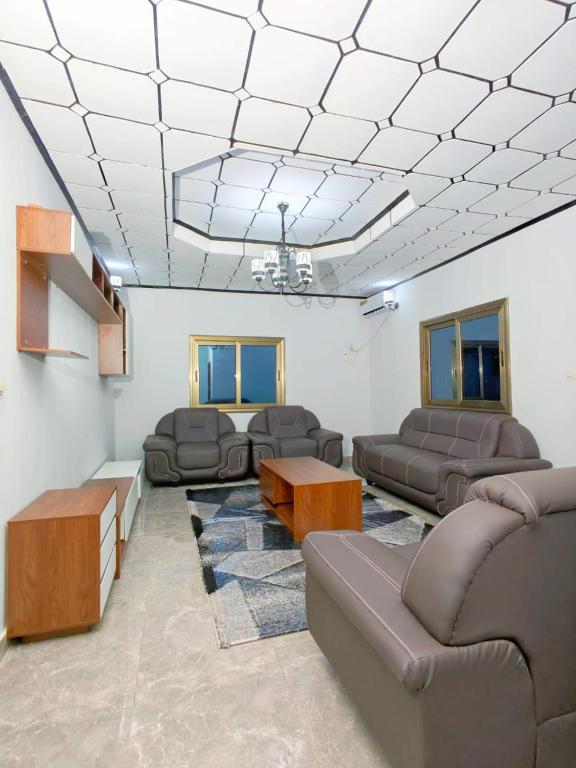 a living room with couches and a couch and tables at Keitaya Dubreka Guinea in Conakry