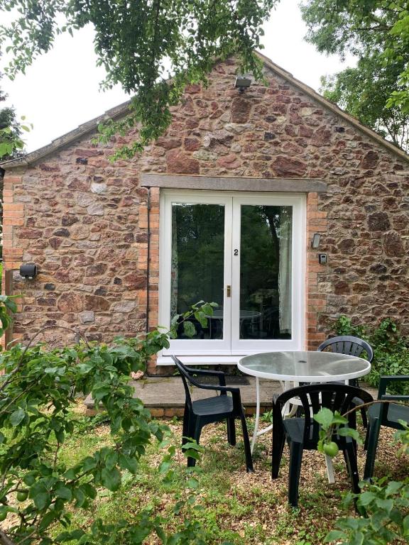 a patio with a table and chairs in front of a building at The Grange in Bristol