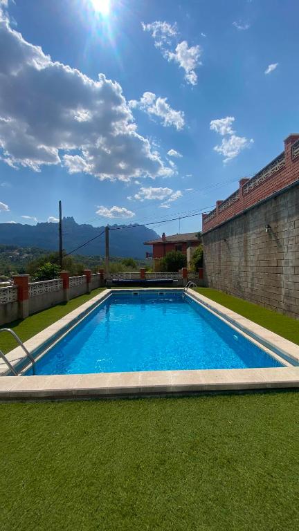 a swimming pool in the middle of a yard at La Casa de la Vall in Castellbell i Vilar