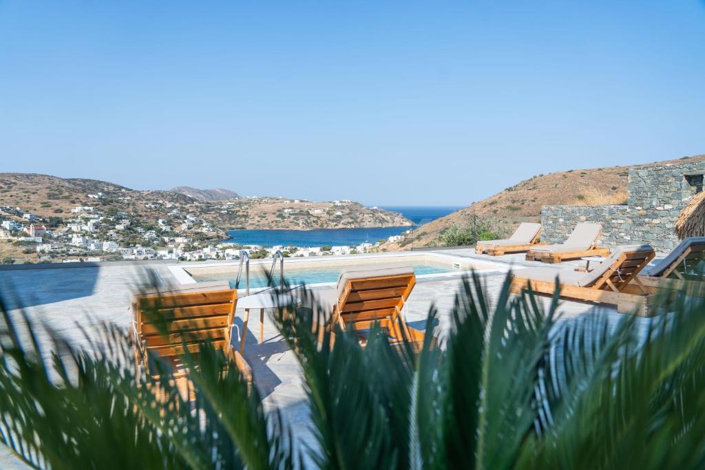a group of chairs sitting next to a swimming pool at Keiz Retreat in Ermoupoli