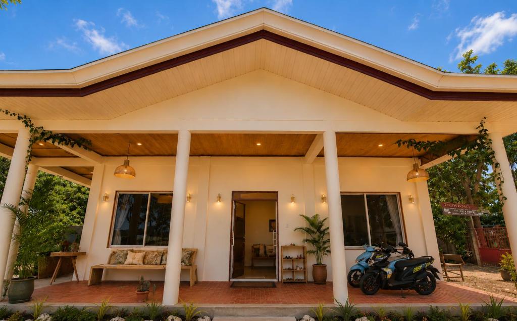 a house with a motorcycle parked in front of it at Durano Seaside Retreat in Mercedes