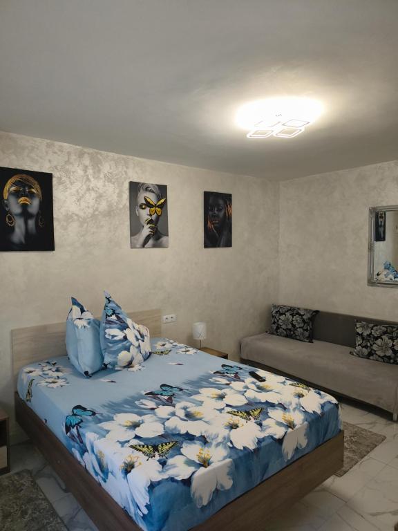 a bedroom with a bed with a blue comforter at Apartament TIMEEA Baile Herculane in Băile Herculane