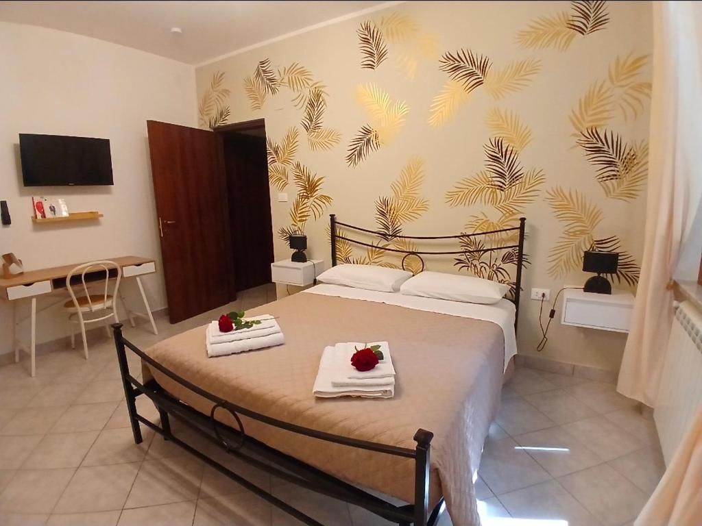 a bedroom with a bed with two towels on it at Marruvium 1937 in Avezzano