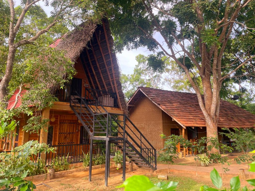 a house with a spiral staircase in front of it at Ama Villa - Habarana in Habarana