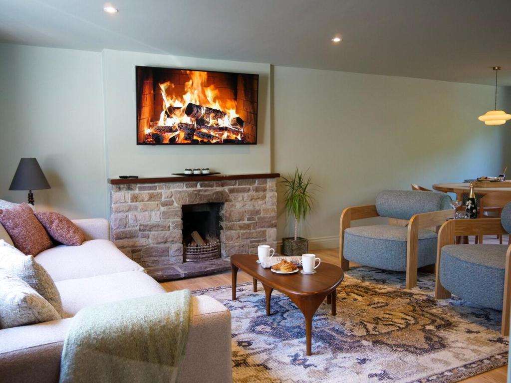 a living room with a couch and a fireplace at Cottage on the Lane Dingle in Dingle