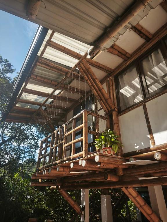 a house with a balcony with plants on it at Suite Central Campestre - Casa Matula in Popayan