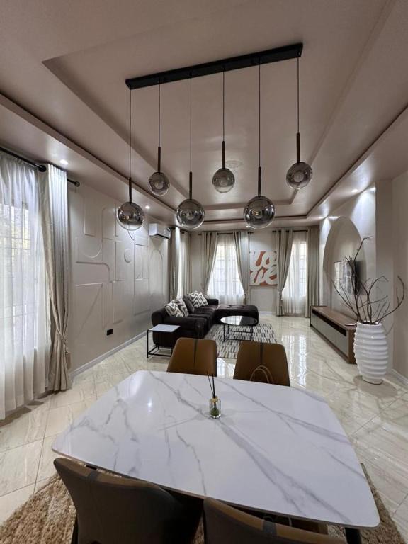 a living room with a large white table and chairs at Raya in Lagos