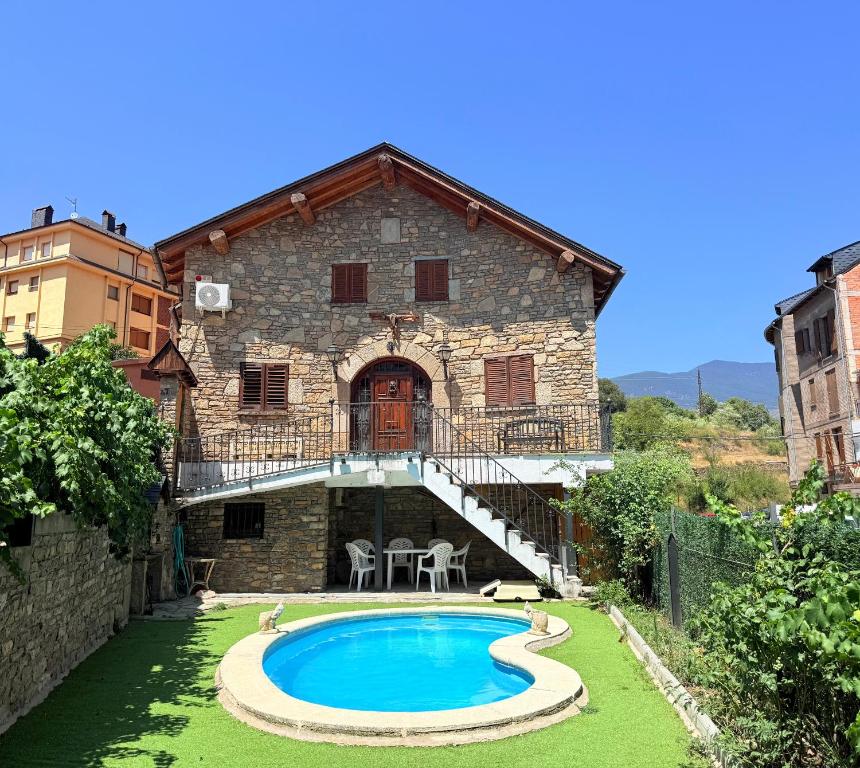 a house with a swimming pool in front of it at Can Florido - L'Amfitriona in Sort
