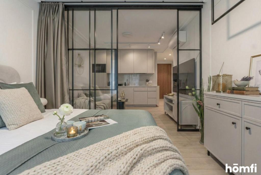 a bedroom with a bed and a living room at Libra Luxury AC - homfi Collection in Krakow