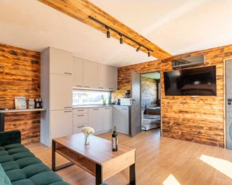 a living room with a couch and a table at Apartament Glamour II Kleszczów in Łękińsko