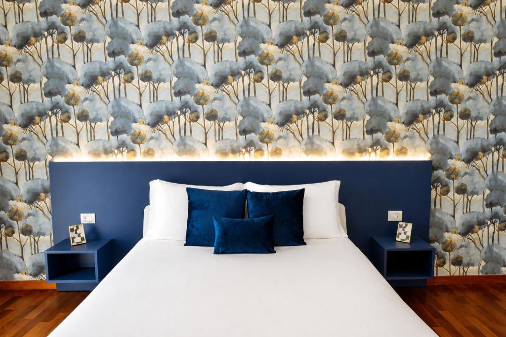 a bedroom with a bed with a blue wall at B&B Best Hostel Milano in Milan