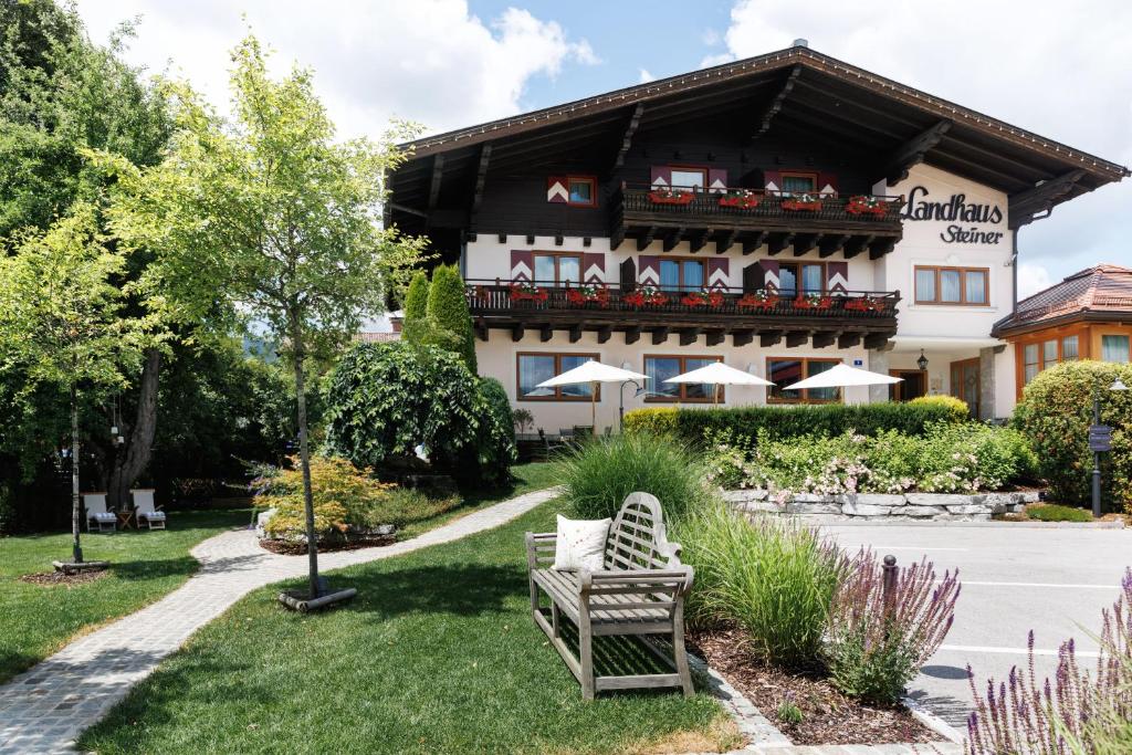 a building with a bench in front of it at Landhaus Steiner in Altenmarkt im Pongau
