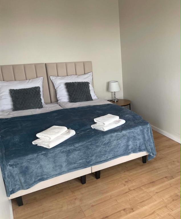 a bedroom with a bed with towels on it at Rubinkowo Rooms Self Check-in 24h in Toruń