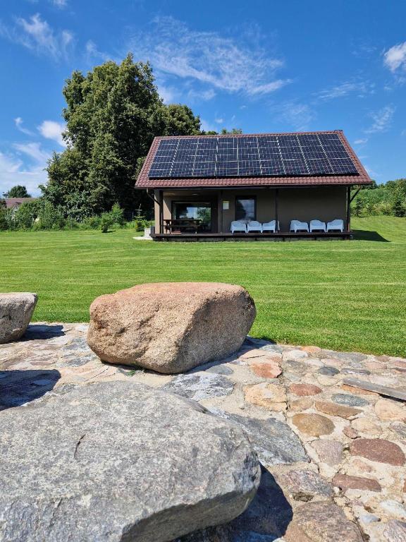 a house with solar panels on the roof at Gardenvillage house in Daržininkai