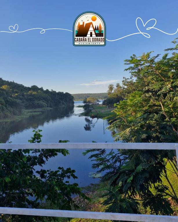 a view of a river with trees and a sign that reads farm island preserve at Cabaña El Dorado, Alojamiento in Puerto Cantera