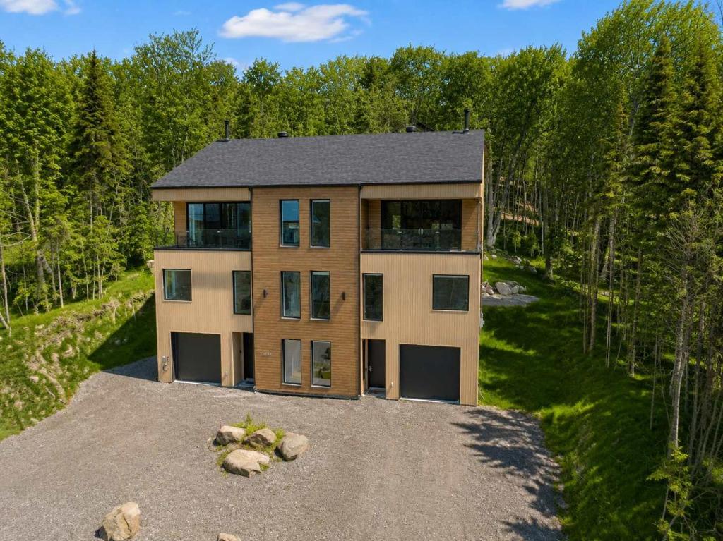 an aerial view of a house on a road at Mountain - Sauna - Camp de base du Massif in Saint-Philémon