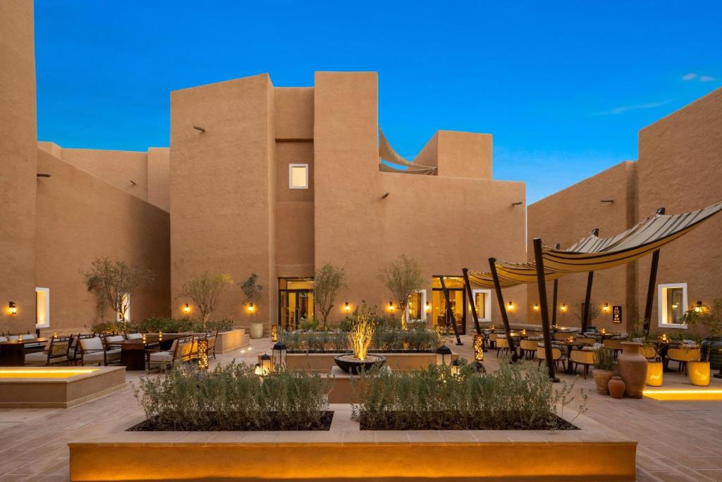 a building with tables and chairs in a courtyard at Bab Samhan, a Luxury Collection Hotel, Diriyah in Riyadh