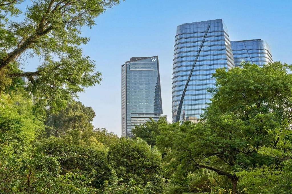 two tall buildings in a city with trees at W Sao Paulo in São Paulo