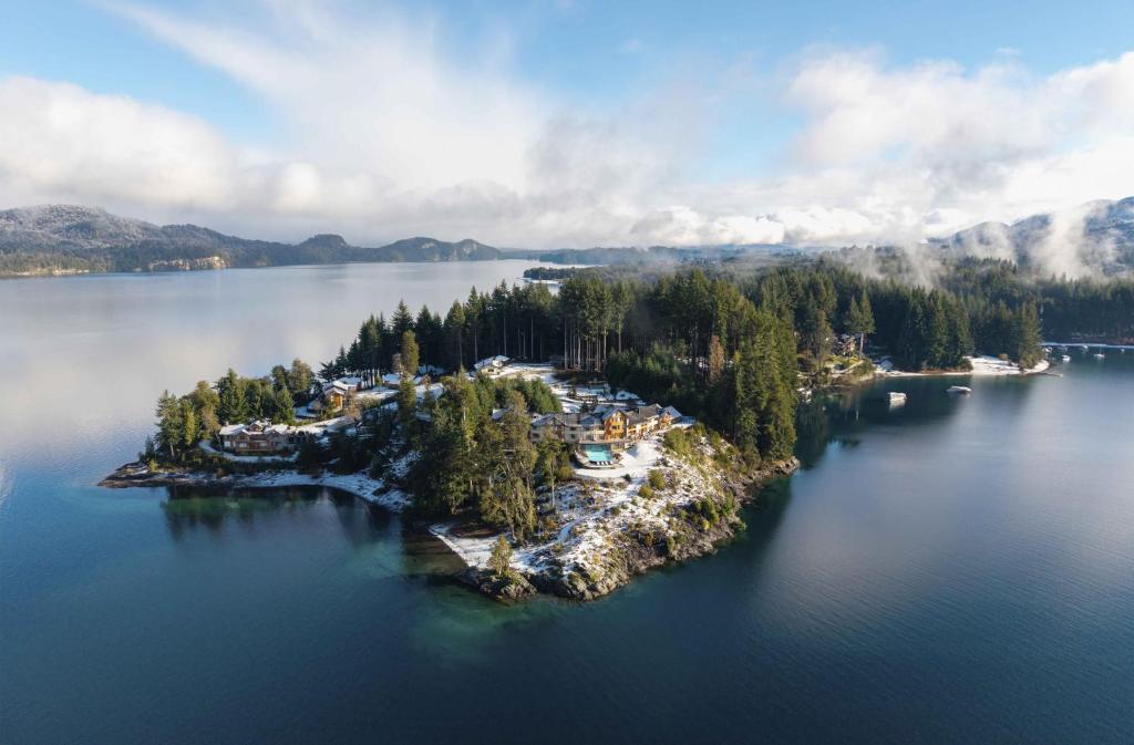 an island in the middle of a large body of water at Puerto Manzano Boutique Hotel in Villa La Angostura