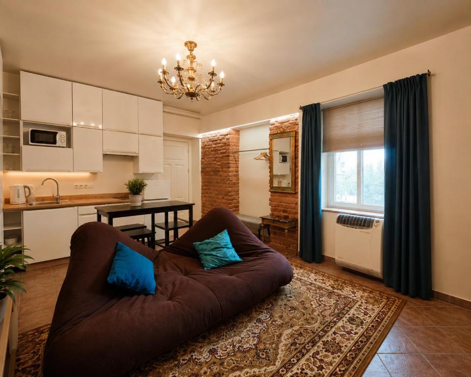 a living room with a couch and a kitchen at Old town boutique apartaments in Ukmergė
