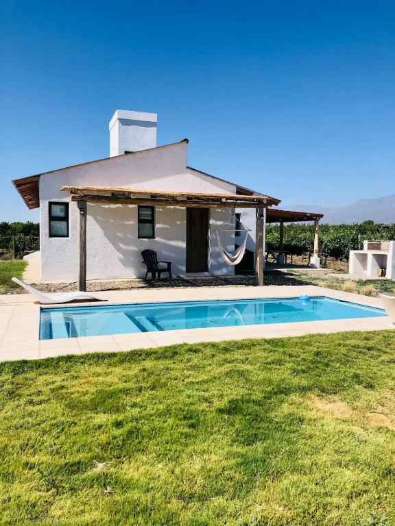a villa with a swimming pool in front of a house at Finca Rosablanca Casa Jazmin in Vista Flores