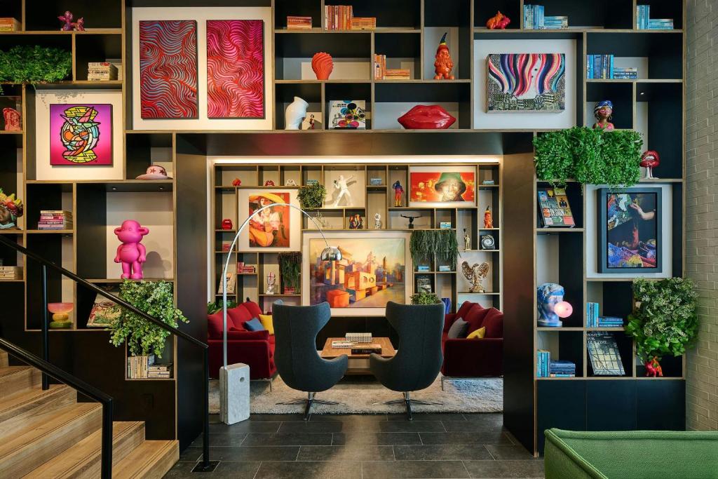 a room with a desk and two chairs at citizenM Washington DC Georgetown in Washington, D.C.